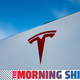 A photo of a Tesla logo on a building with The Morning Shift banner on the bottom.